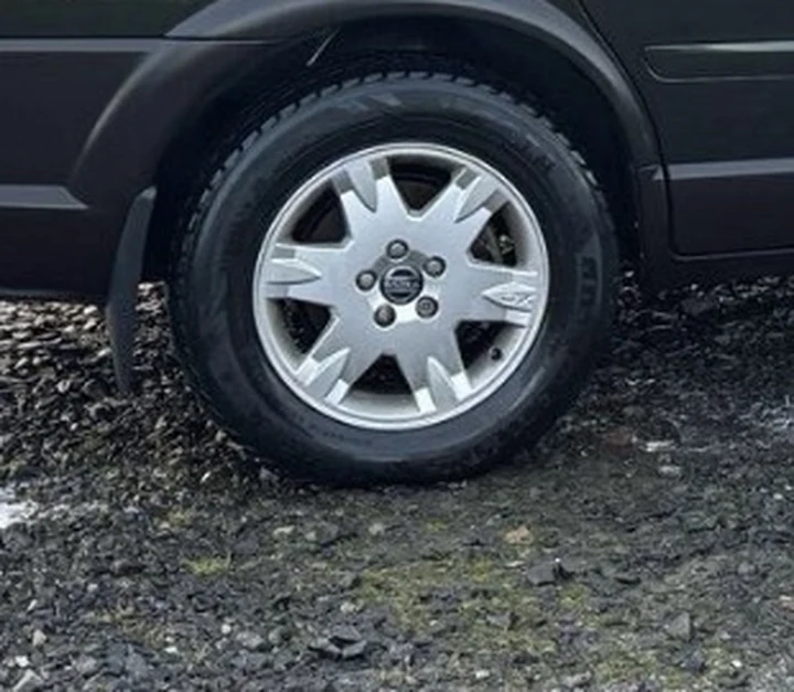 Close-up of the test Volvo XC70 rear alloy showing light brake dust on the inner spokes, no corrosion, no kerb damage
