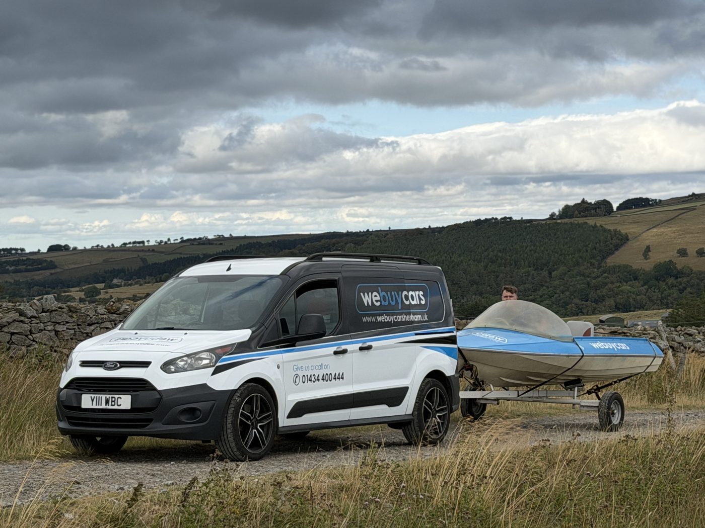 Jack Robson, Mick's son, sat in a boat in the same seat and pose on the moors, August 2026