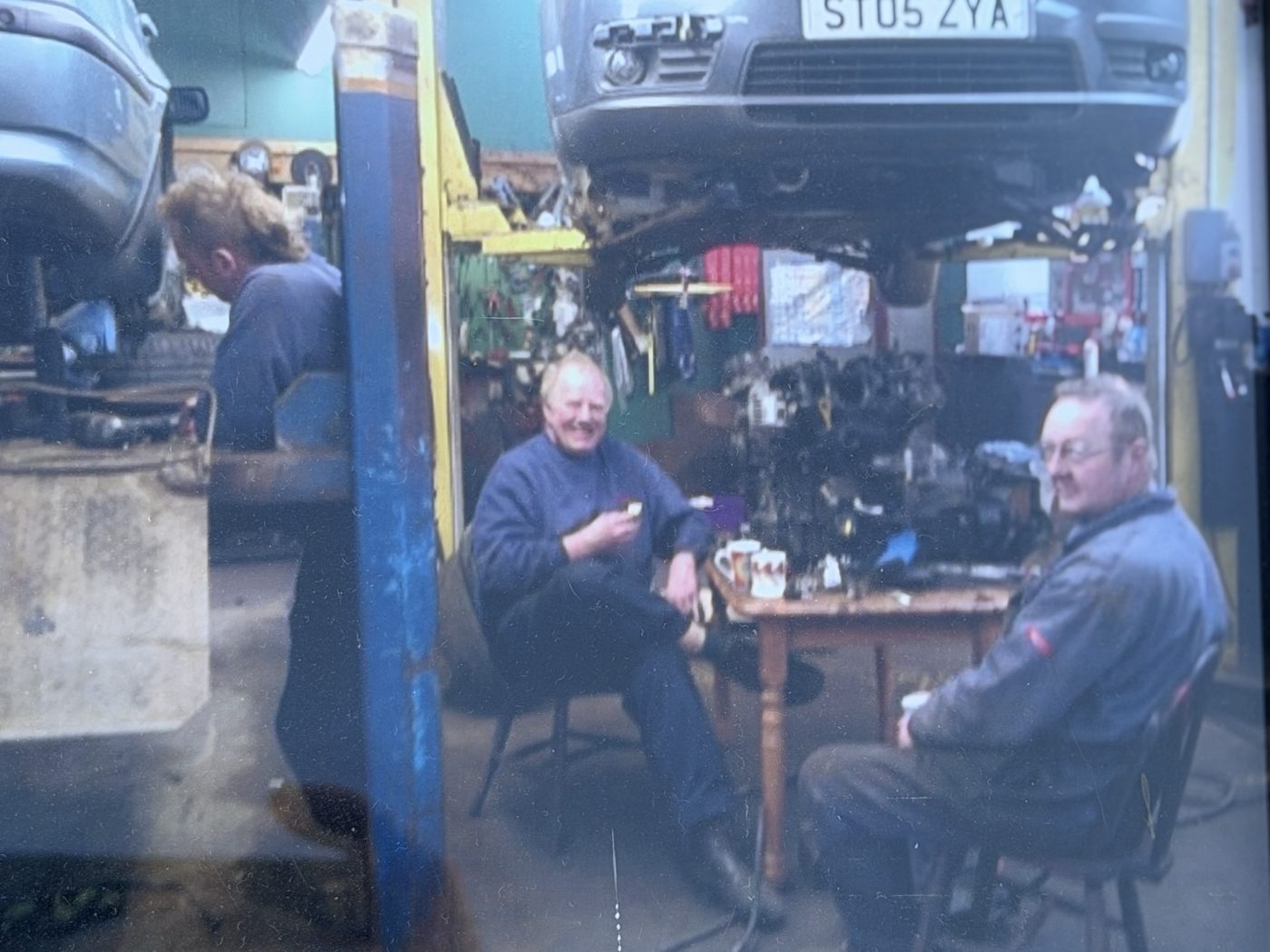 Tea break in the workshop at the farm, mid-repair, in the Allendale Motor Company years