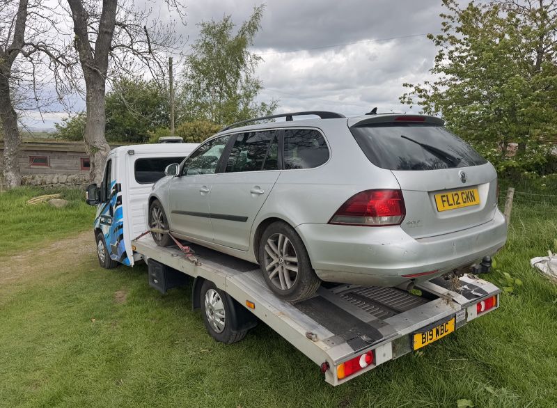 A silver VW Golf Estate on the We Buy Cars Hexham flatbed recovery truck in Allendale